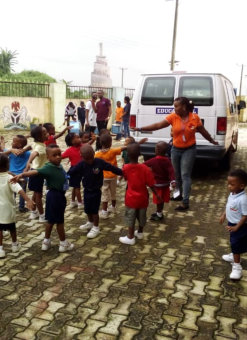 children looking at a white van