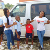 people standing beside a white car